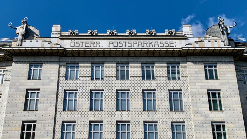 Photo of the top front of the Postsparkasse building in Vienna