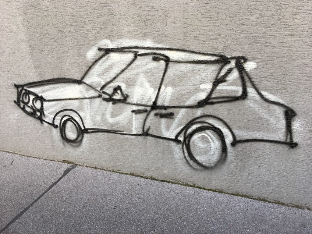 Grafitti spray painted image of an automobile, Vienna 2018.